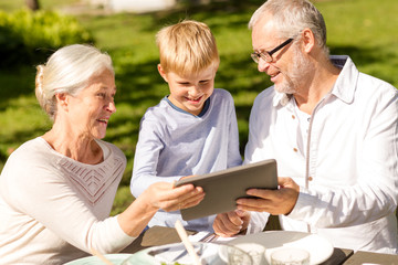 happy family with tablet pc outdoors