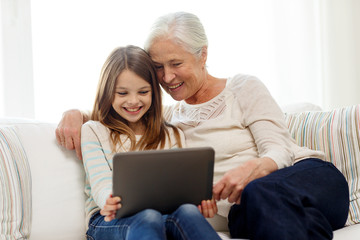 smiling family with tablet pc at home