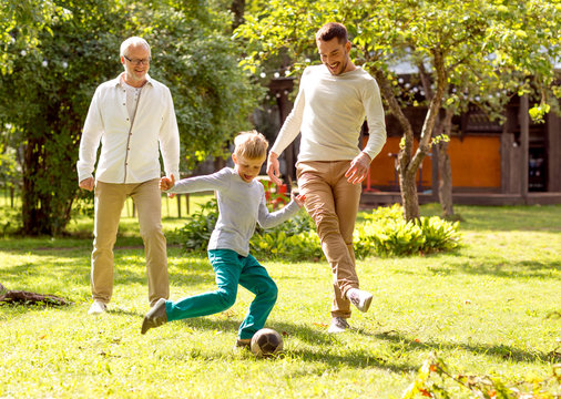 happy family playing football outdoors