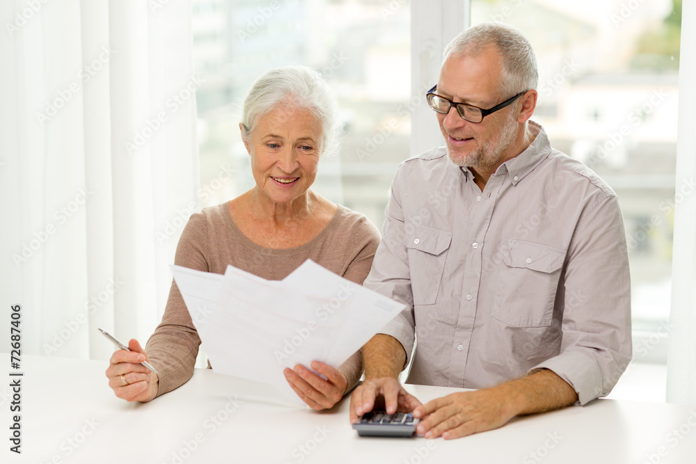 Sticker senior couple with papers and calculator at home