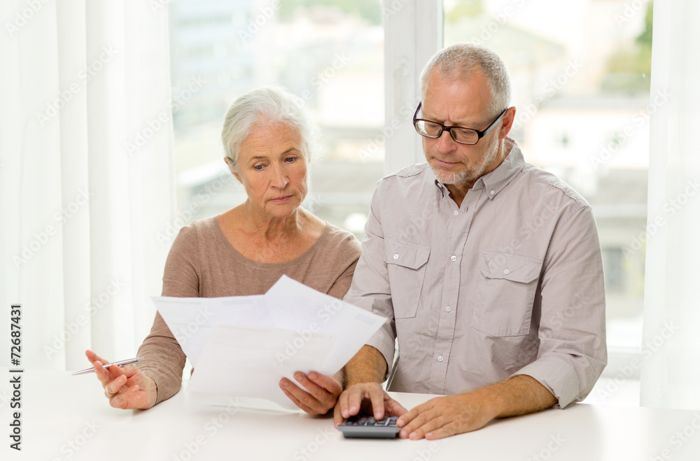 Wall mural senior couple with papers and calculator at home