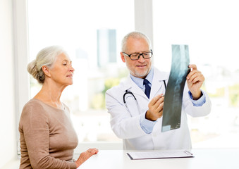 smiling senior woman and doctor meeting