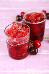 Closeup of cherry granita in glasses, on color wooden