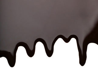 Melted chocolate dripping on white background