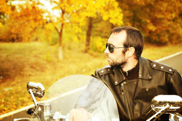 Biker man sits on bike