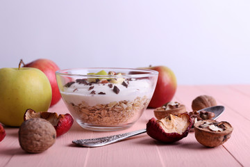 Oatmeal with yogurt in bowls/bowl, apples and walnuts
