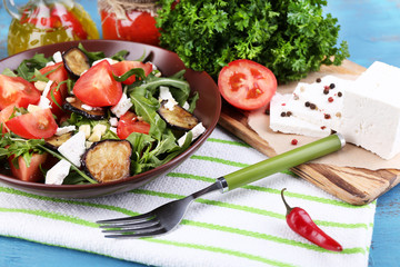 Eggplant salad with tomatoes, arugula and feta cheese,