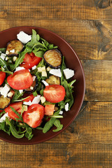 Eggplant salad with tomatoes, arugula and feta cheese,