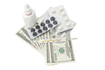 Pills in a blister pack, thermometer and nasal spray with US dol