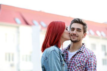 Loving couple near apartment house