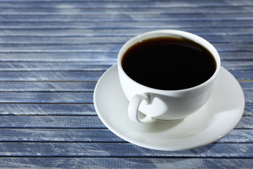 Cup of coffee on wooden table