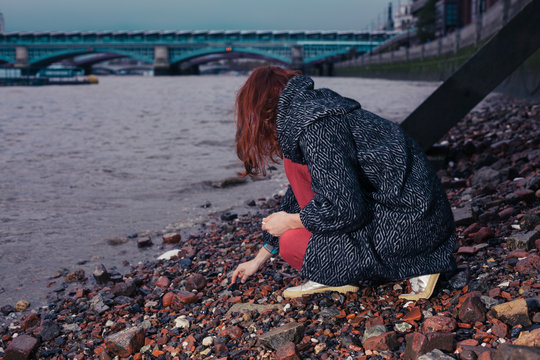 Young woman beachcombing in city