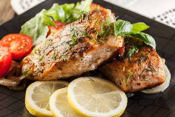 Fried salmon steak with vegetables