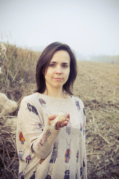 brunette girl in the countryside with dry field background