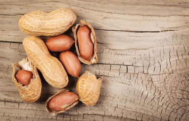 Peanuts in shells on wood background