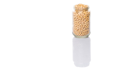 Soybean in a glass jar over white background
