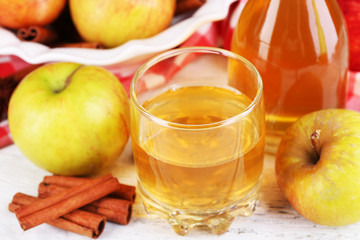 Apple cider with cinnamon sticks and fresh apples