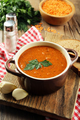 Delicious lentil cream-soup on table close-up