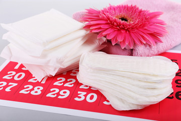 Sanitary pads, calendar, towel and pink flower