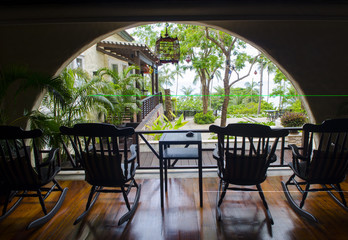 group of relaxing rocking chairs overlooking peaceful mountain view on porch of luxury resort hotel