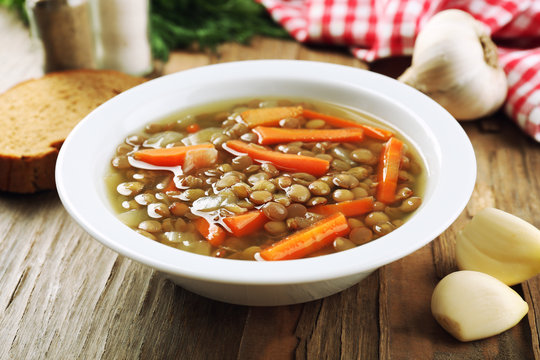 Delicious lentil soup on table close-up