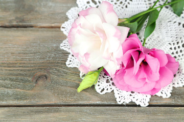 Beautiful eustoma flowers on wooden background