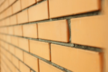 Orange brick wall close-up background