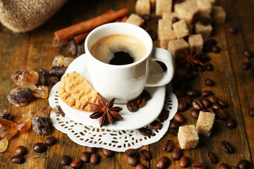 Cup of coffee and tasty cookie on wooden background