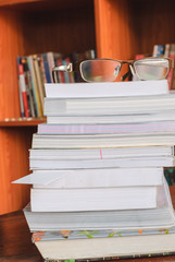 pair of glass on books