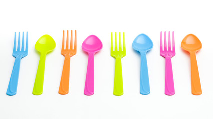 Colorful fork and spoon on white background