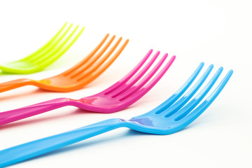 Close up colorful forks on white background