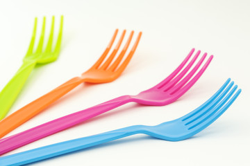 Close up colorful forks on white background