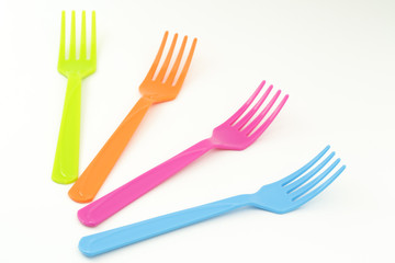 Close up colorful forks on white background