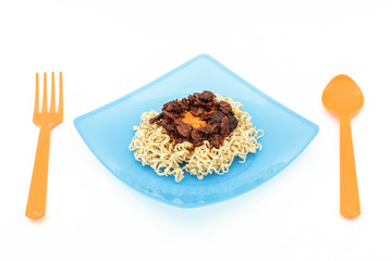 Eating noodles with fork and spoon on white background