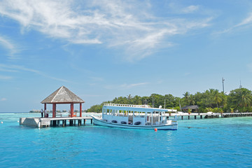 Passenger boat docked at Maldives resort.