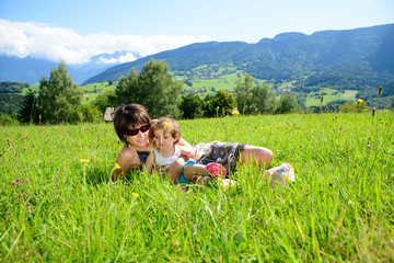 Fototapeta na wymiar a beautiful mother and daughter lying on the grass