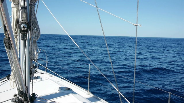 Sailing at sunny day on blue sea with sailboat