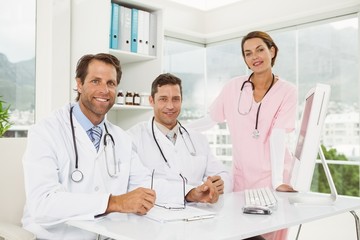 Confident doctors smiling at medical office