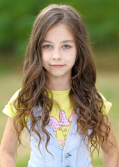 Naklejka premium portrait of little girl outdoors in summer