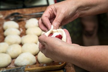 woman hands making cakes with berries