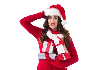 Stressed brunette in santa hat holding gifts