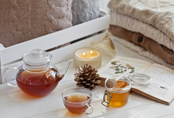 Cozy wool winter accessory. Warm sweaters, tea, cone, and candle