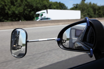 Rear view mirror with extension for driving with a trailer