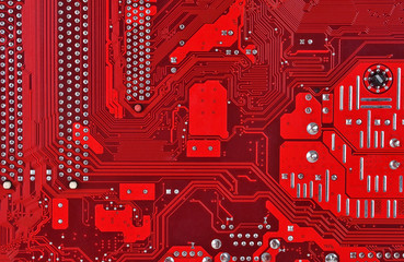 Close up of a printed red computer circuit board