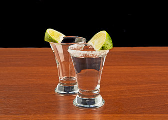 Two glasses of tequila salt and lime