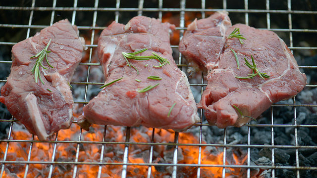 eef Steak on the BBQ Grill with flames.