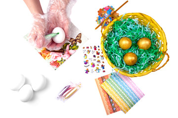 Fototapeta premium Hand of the girl, basket with Easter eggs