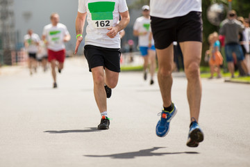 Marathon running race, people feet on autumn road