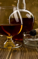 glass and bottle with a cigar