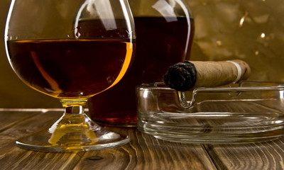 glass and bottle with a cigar